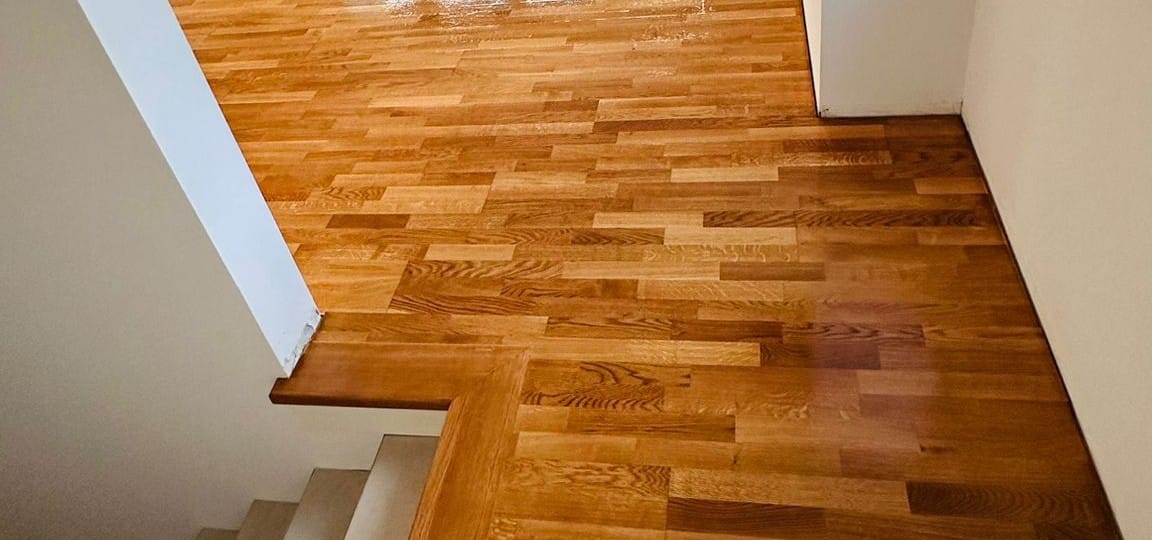 Frisch geschliffenes und versiegeltes Stabparkett am Treppenabsatz
